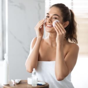 a young lady cleaning her face in the bathroom